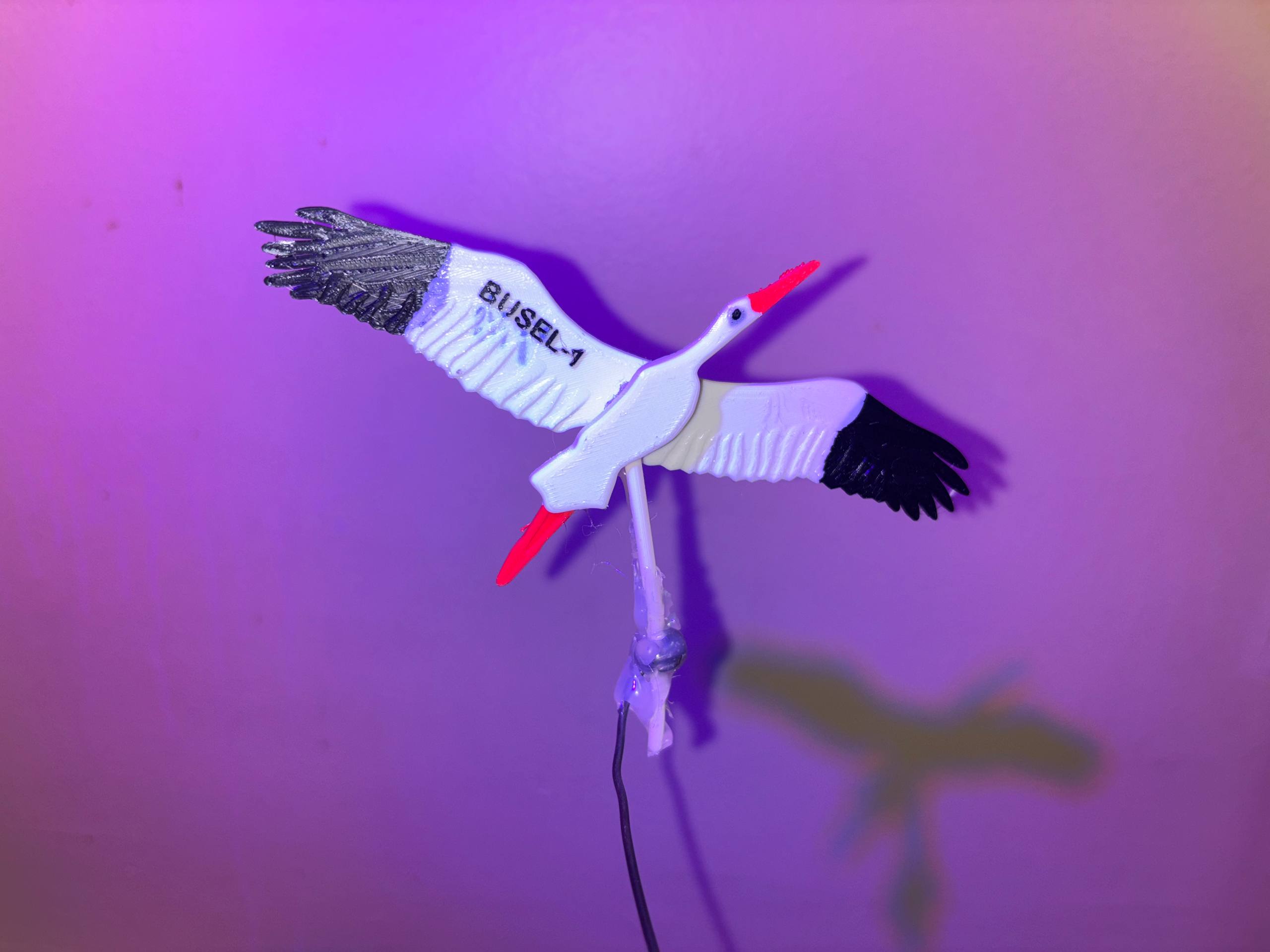 3D-printed white stork figurine, the BUSEL-1 mascot, ready to be attached to the payload
